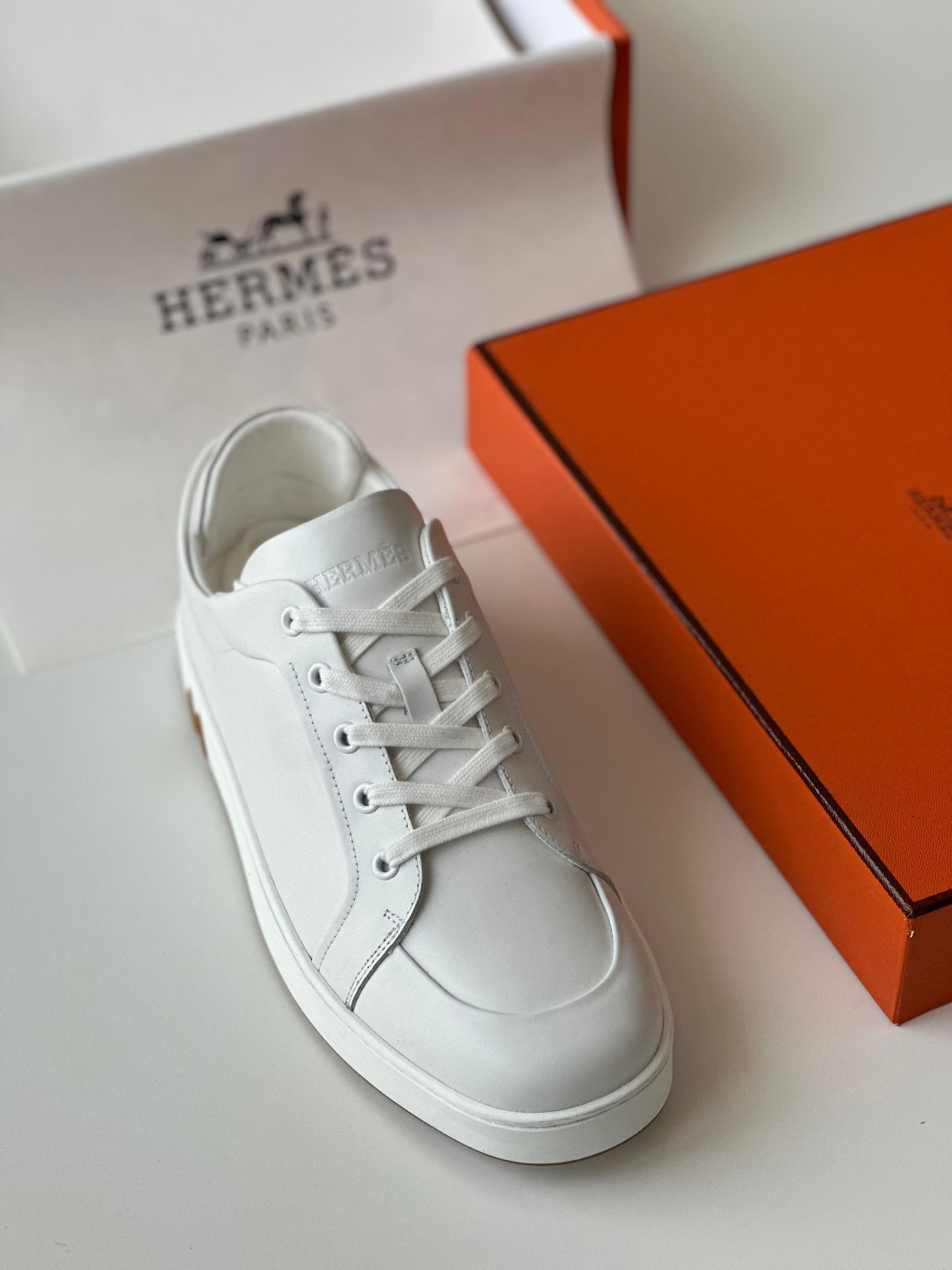 Hermès Kid Sneaker in White Calfskin & Suede – Sleek Urban Luxury.