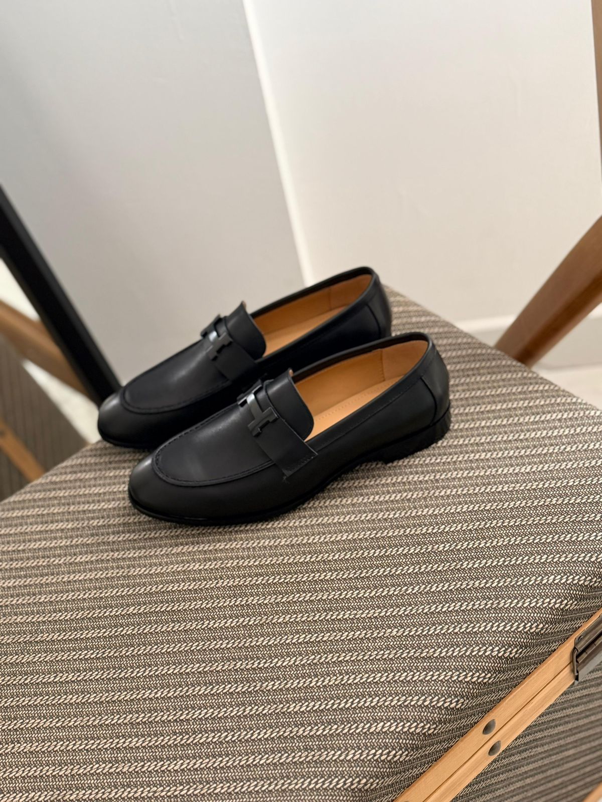 Hermès Paris loafers, a classic slip-on shoe crafted in black grained calfskin