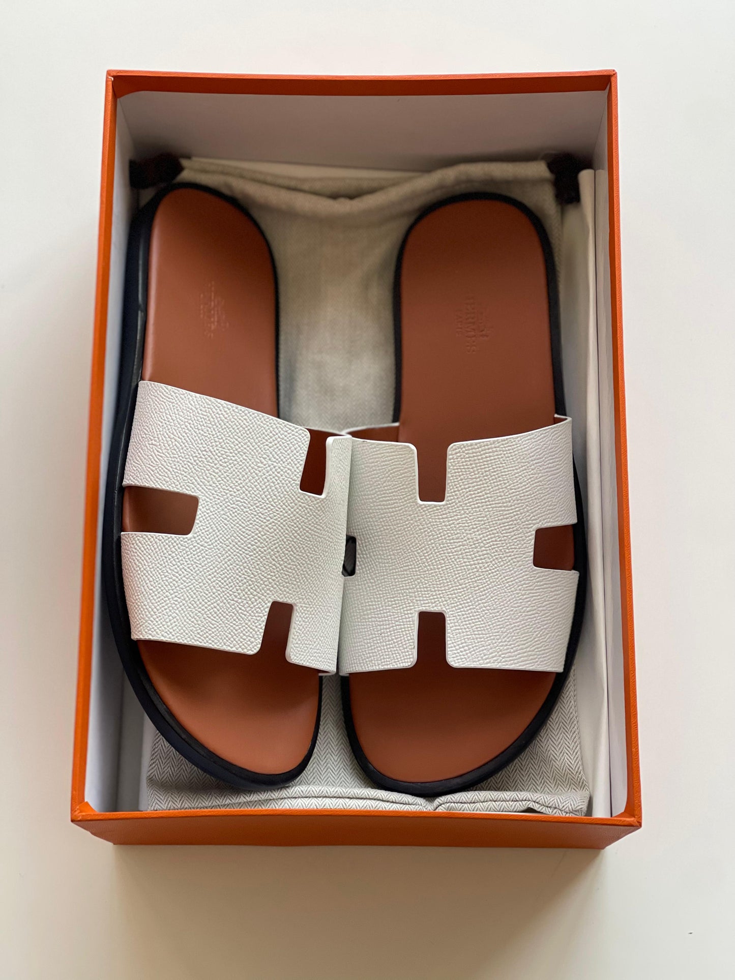 Hermès Izmir Sandal in white calfskin leather iconic "H" cutout.