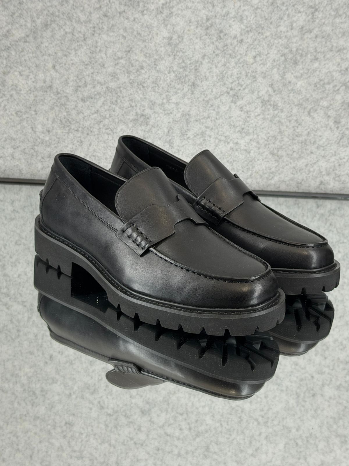 Hermès Klement Loafer in black buffalo leather with a chunky rubber sole.