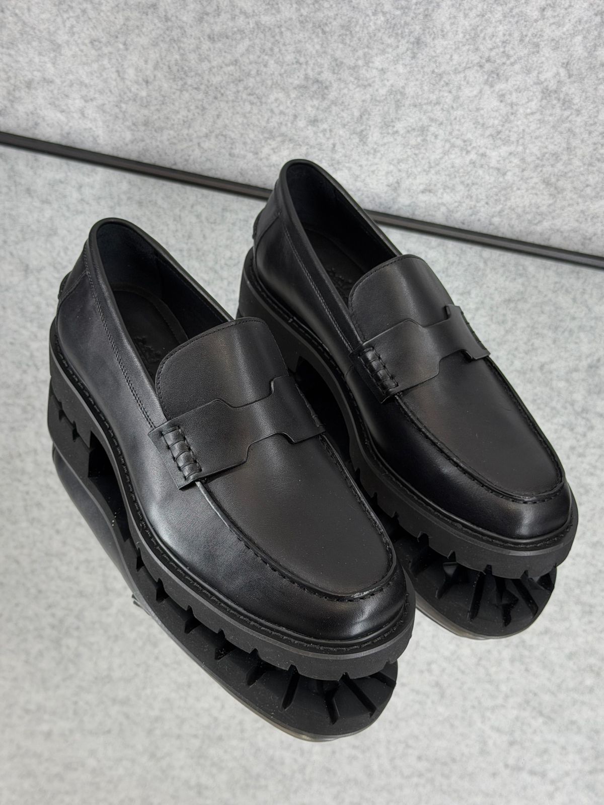 Hermès Klement Loafer in black buffalo leather with a chunky rubber sole.