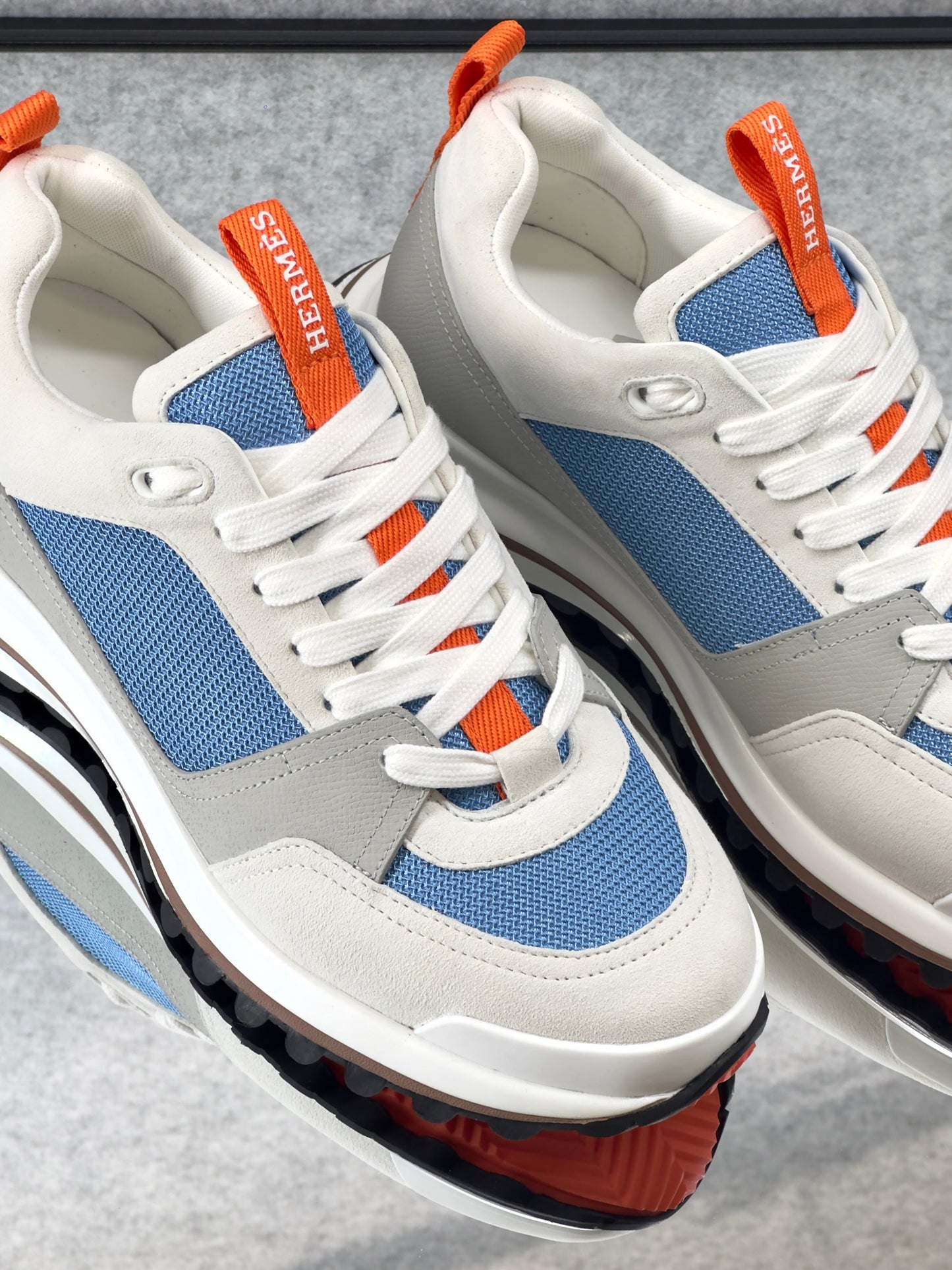 Hermès Leader Sneaker in technical twill, calfskin, and suede goatskin.