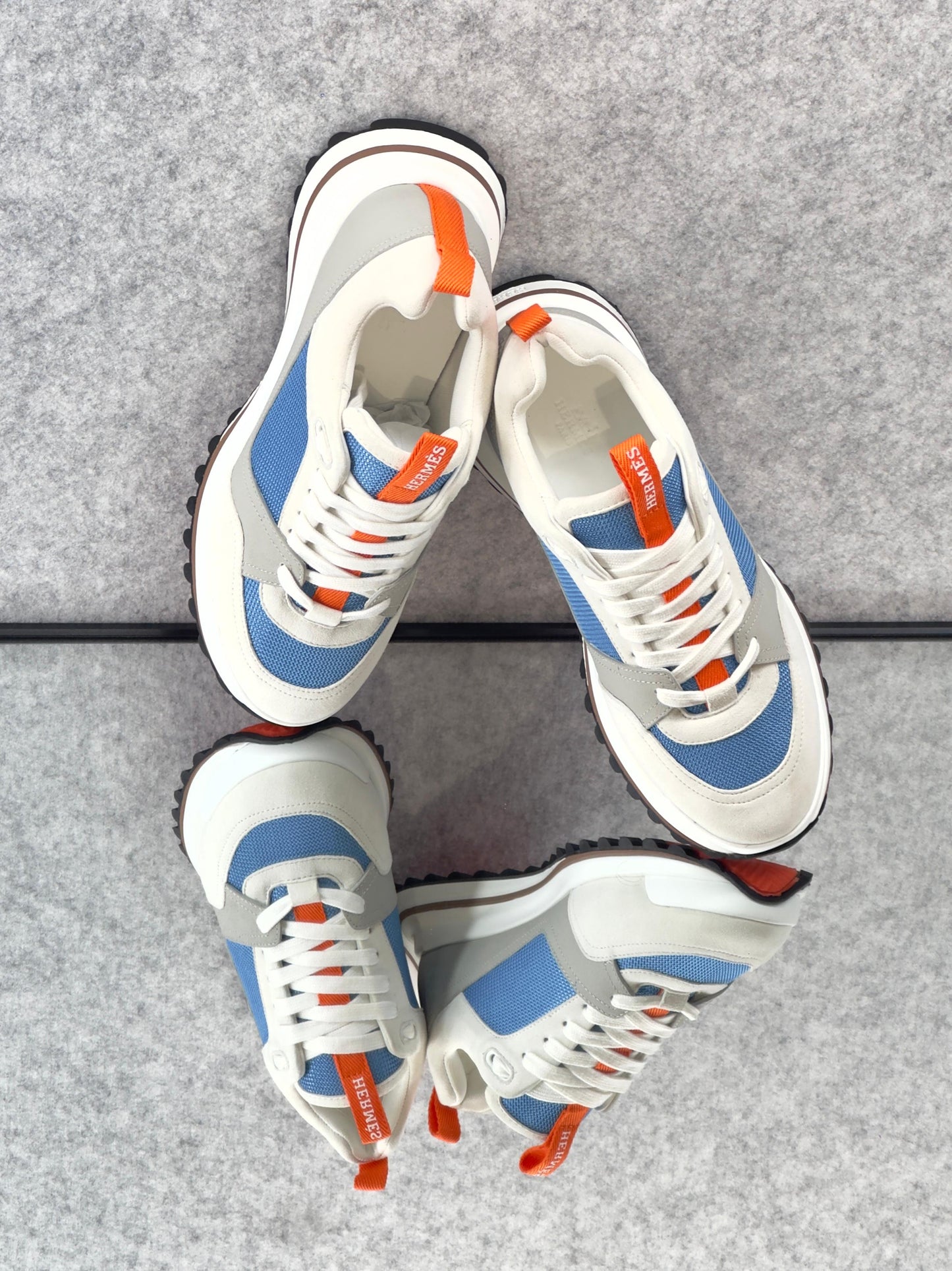 Hermès Leader Sneaker in technical twill, calfskin, and suede goatskin.