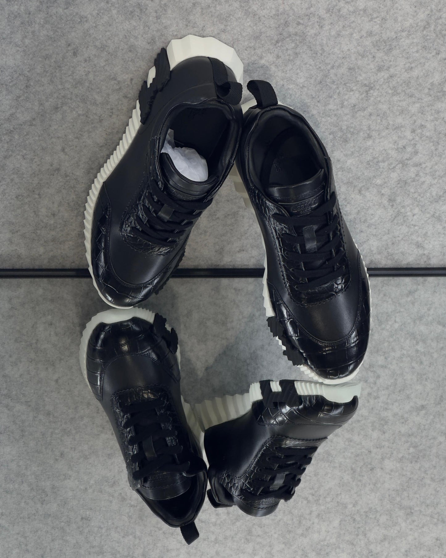 Hermès Bouncing Sneaker, crafted with a combination of materials and featuring a bold, contrasting rubber sole.