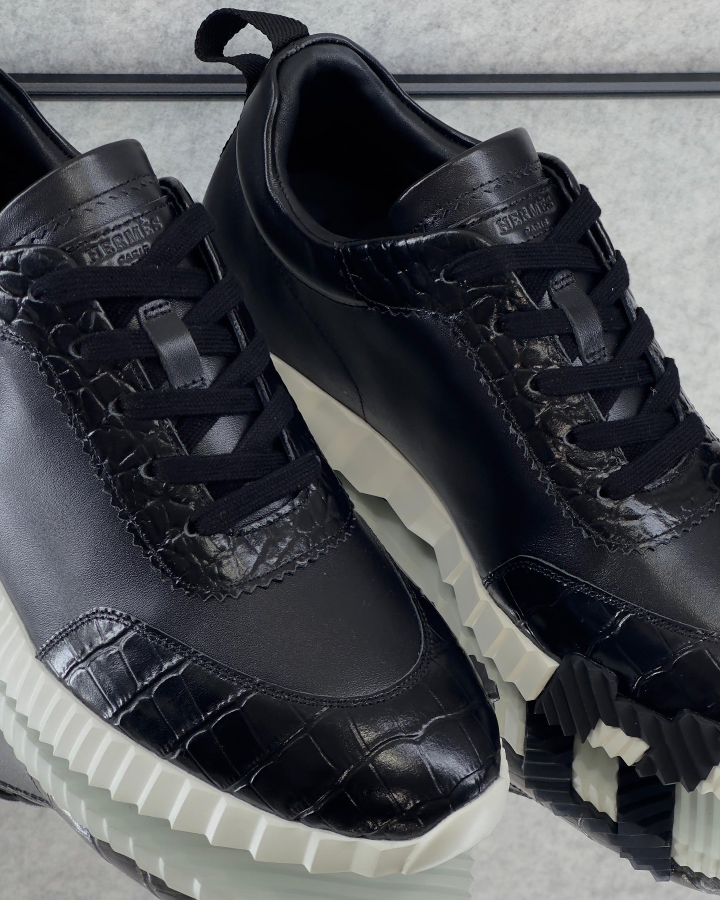 Hermès Bouncing Sneaker, crafted with a combination of materials and featuring a bold, contrasting rubber sole.