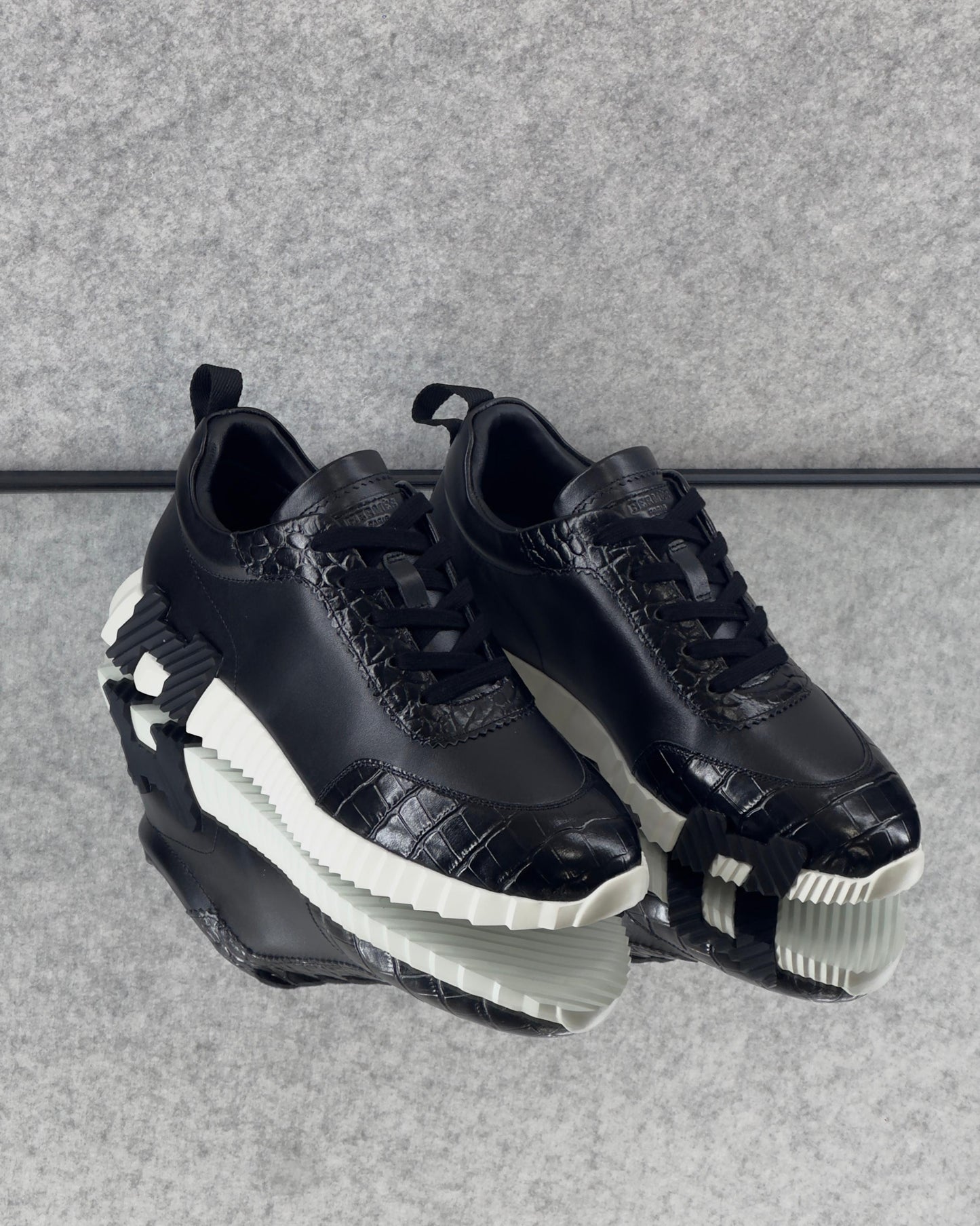 Hermès Bouncing Sneaker, crafted with a combination of materials and featuring a bold, contrasting rubber sole.