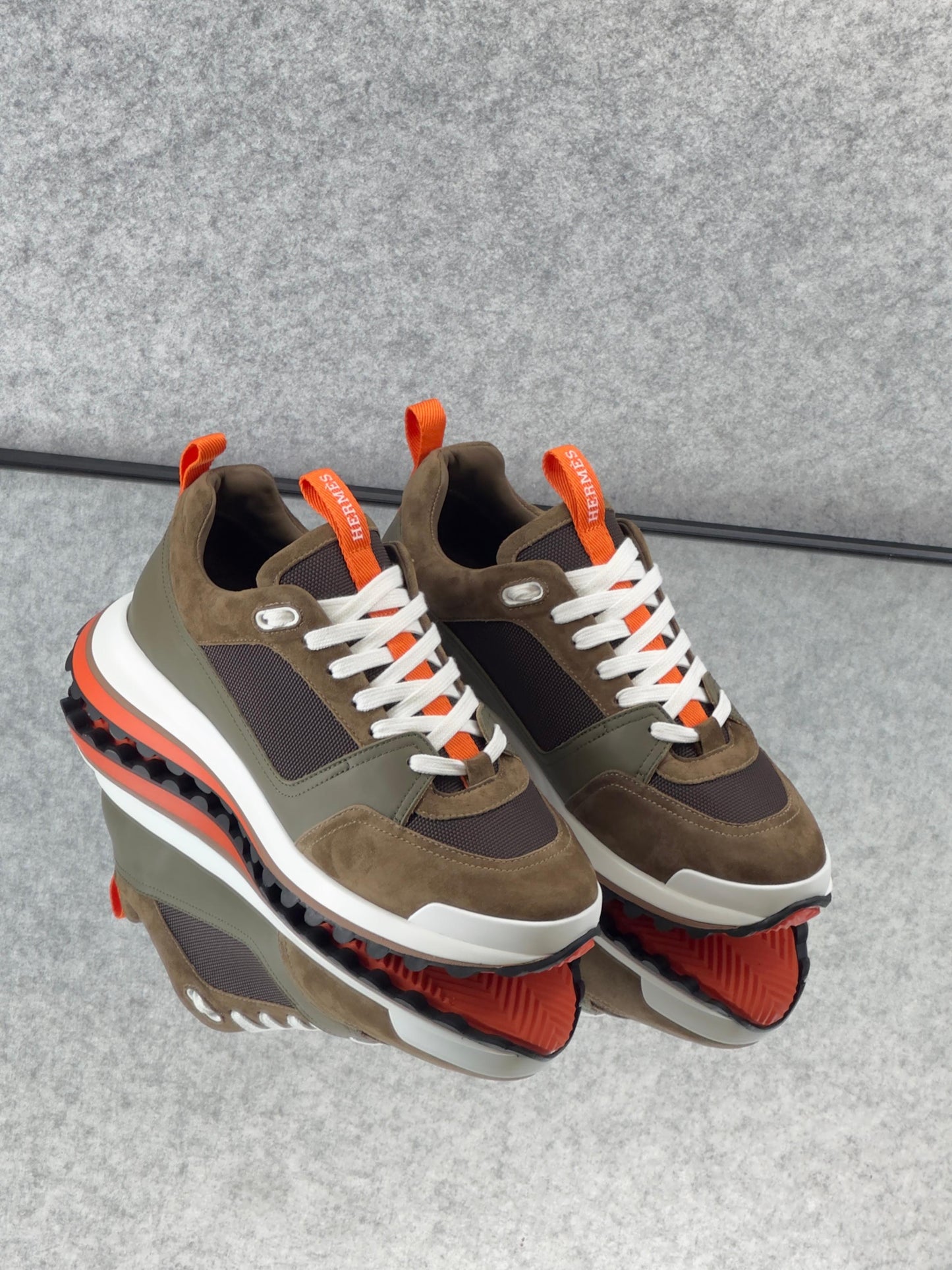 Hermès Leader Sneakers are crafted from a combination of technical twill, calfskin, and suede goatskin.