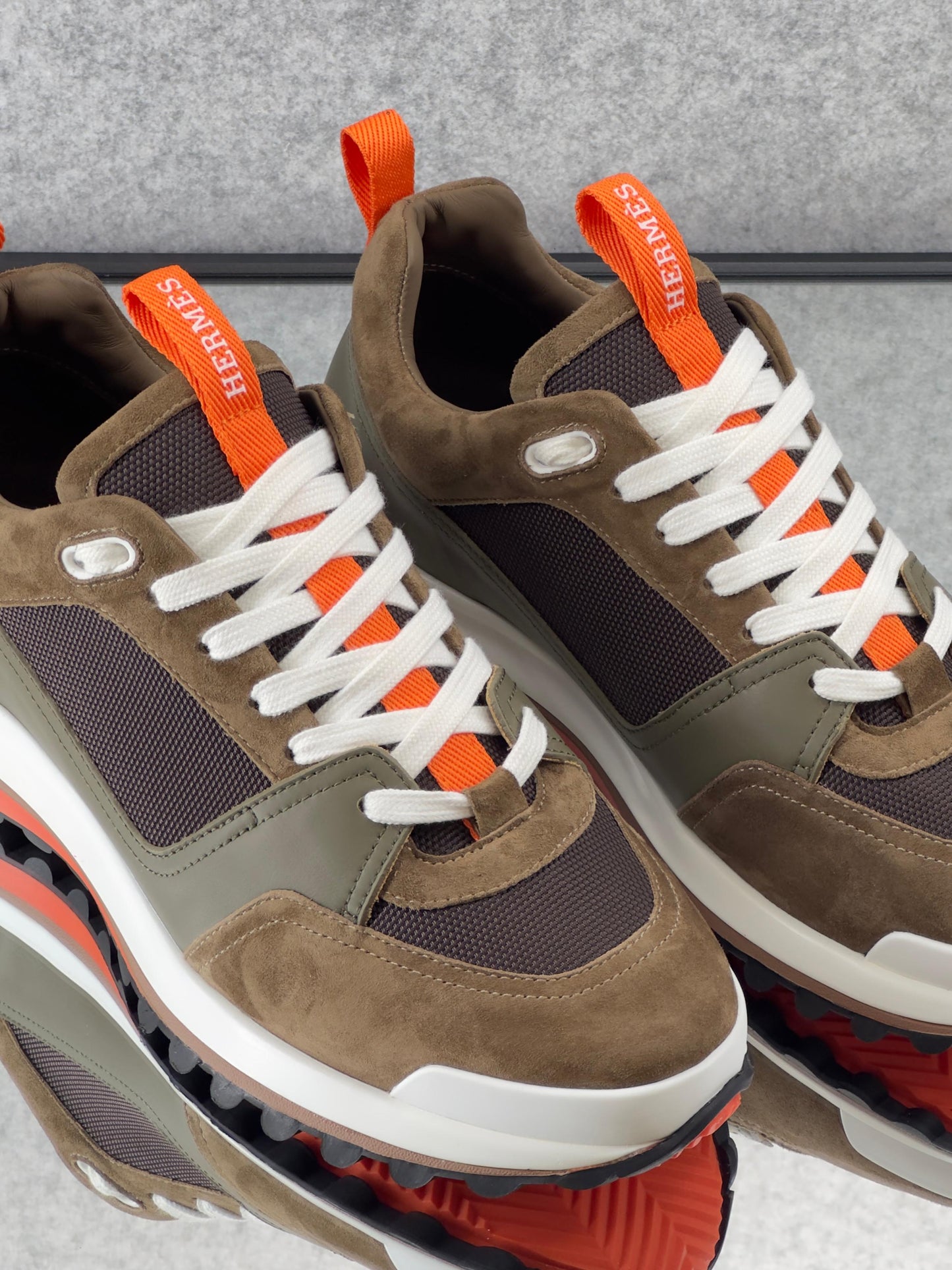 Hermès Leader Sneakers are crafted from a combination of technical twill, calfskin, and suede goatskin.