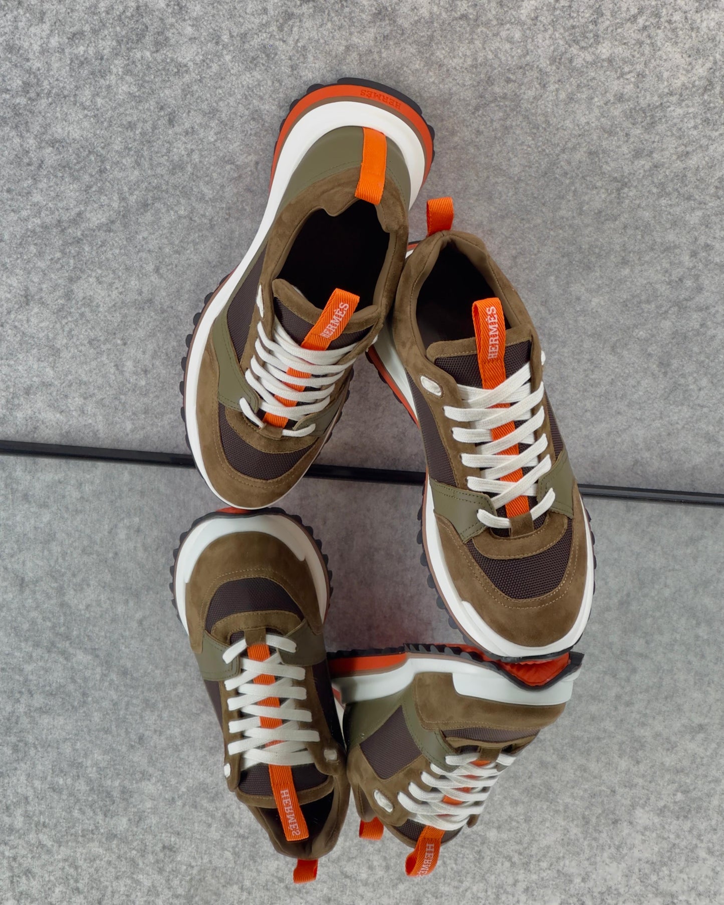 Hermès Leader Sneakers are crafted from a combination of technical twill, calfskin, and suede goatskin.