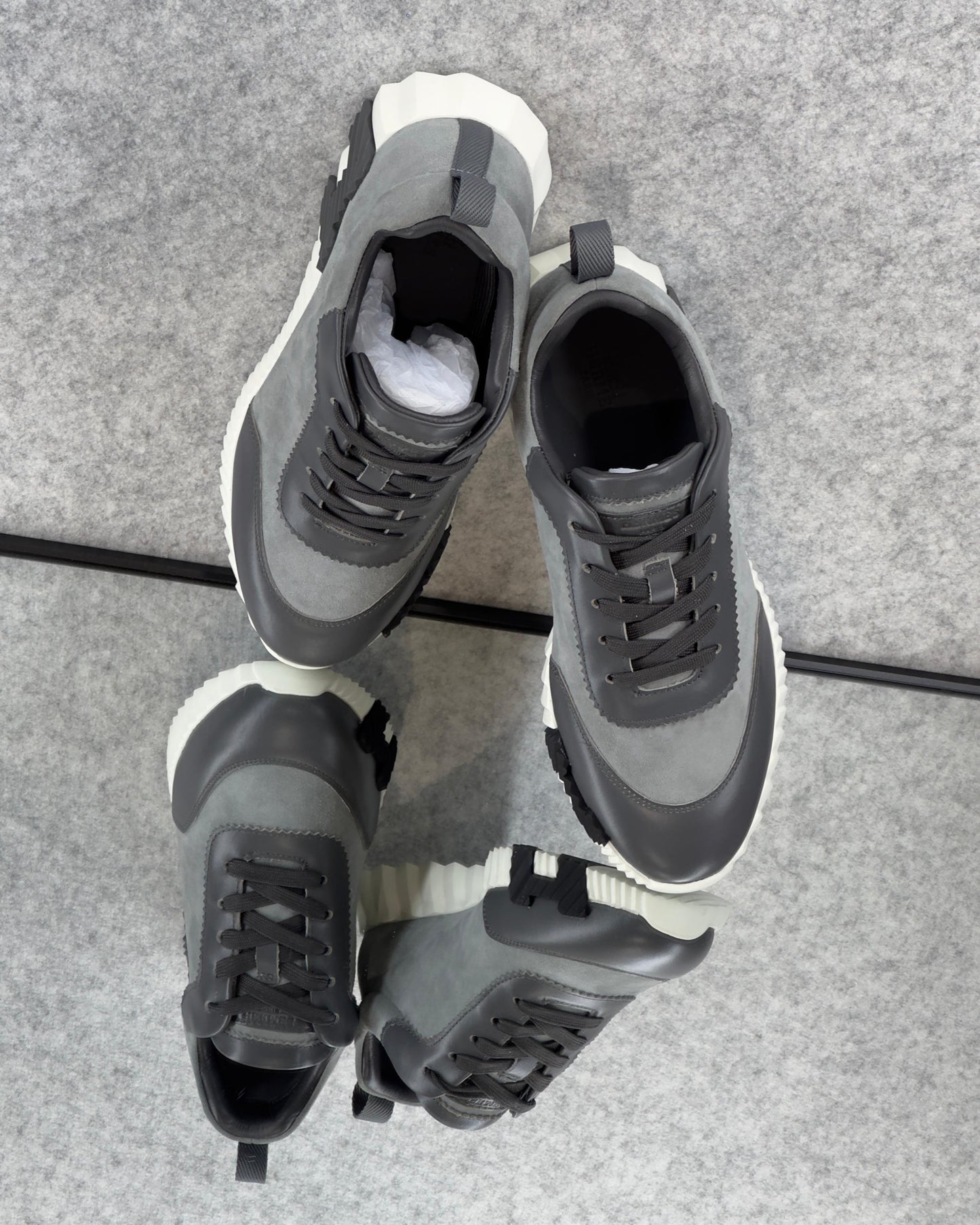 Hermès Bouncing Sneakers in the Gris Orage colorway, crafted from suede goatskin and calfskin.