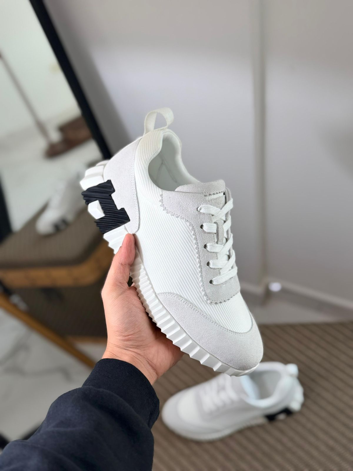 Hermès Bouncing sneaker, a luxury footwear option featuring a distinctive oversized "H" motif on the sole.