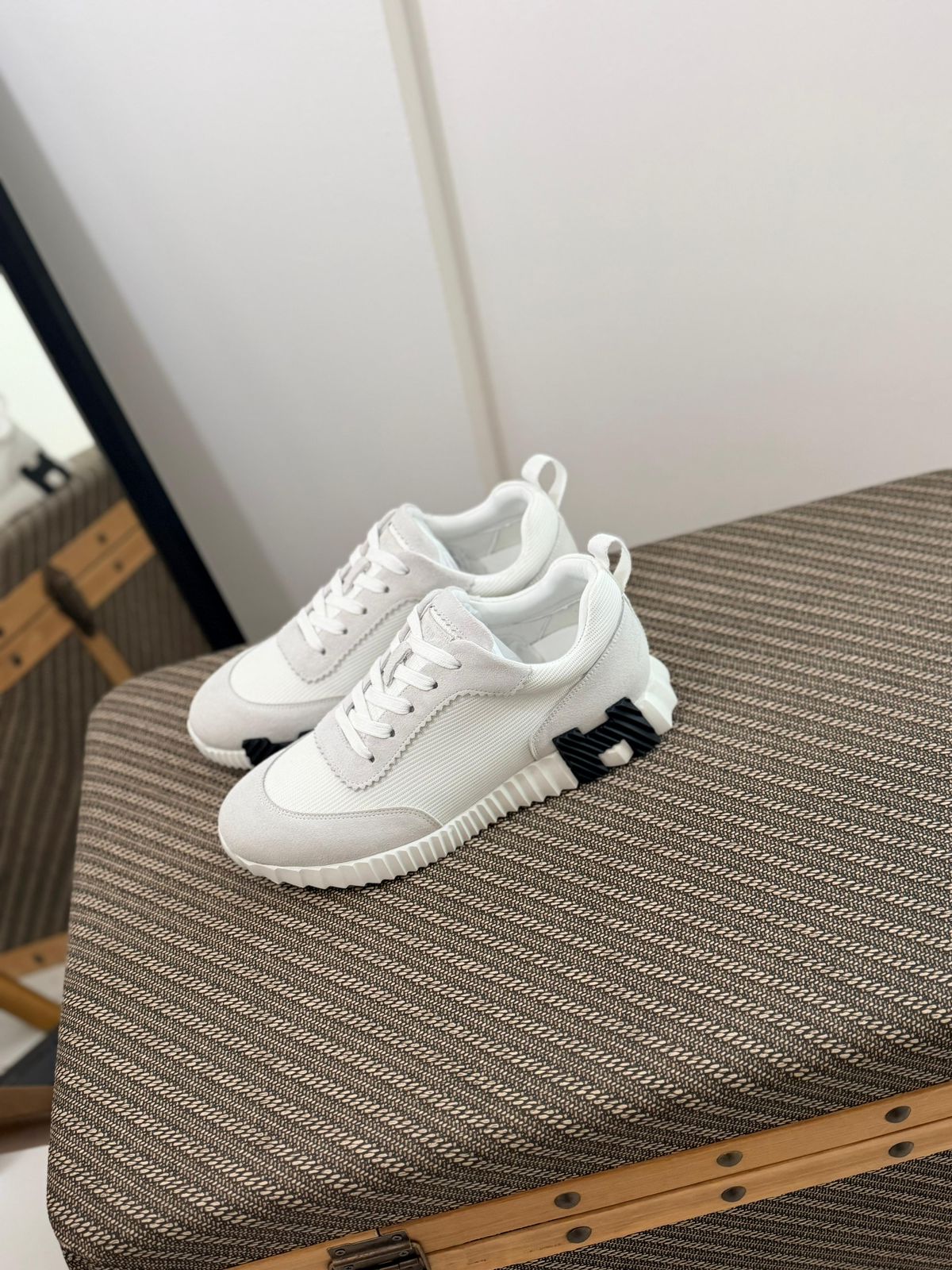 Hermès Bouncing sneaker, a luxury footwear option featuring a distinctive oversized "H" motif on the sole.