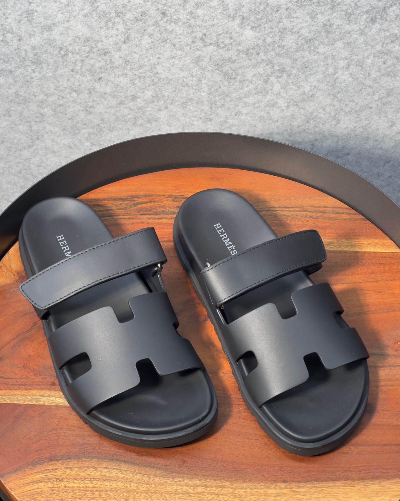Hermès Chypre sandals in black calfskin leather.