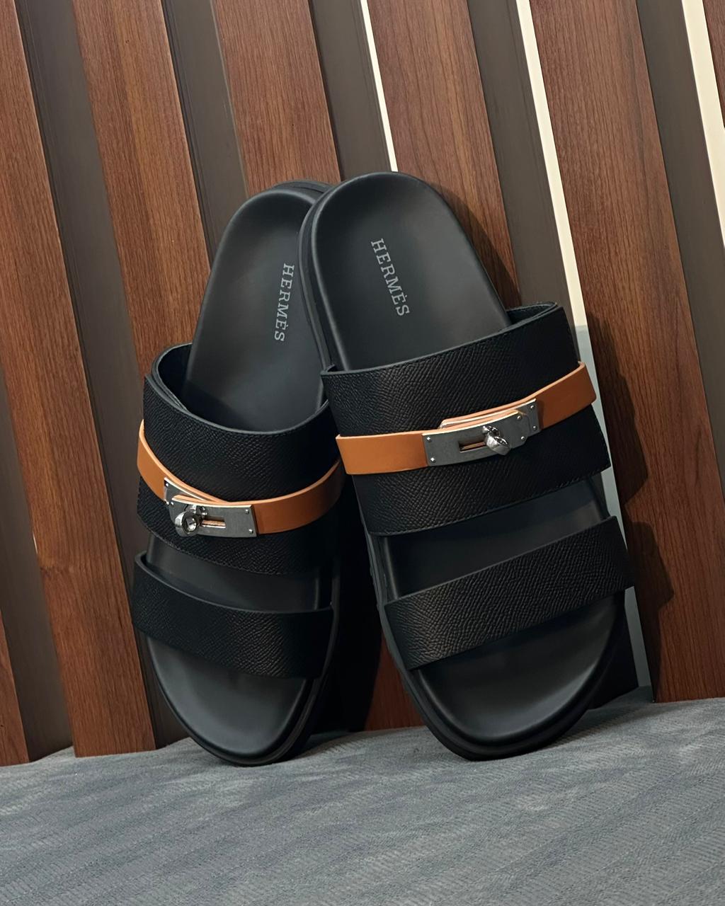 Hermès Jackson Sandals in black leather with a palladium-plated Kelly buckle.