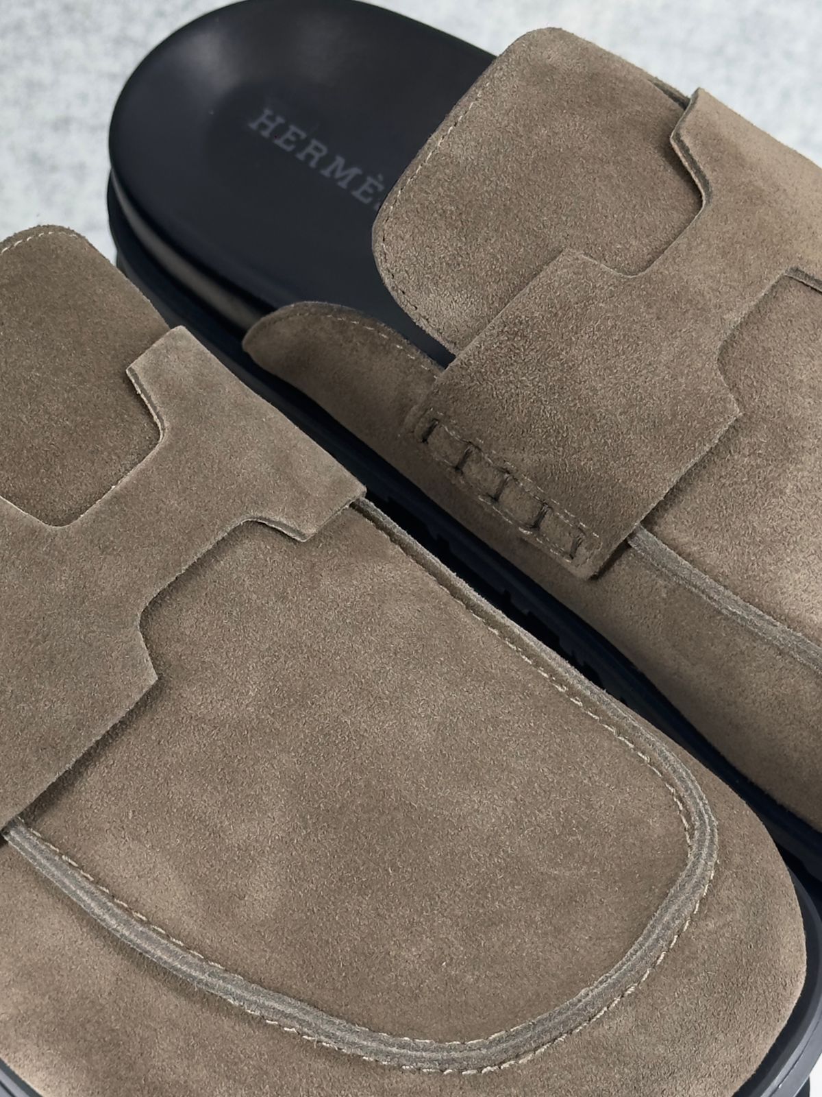 Hermès Go mules in brown suede.
