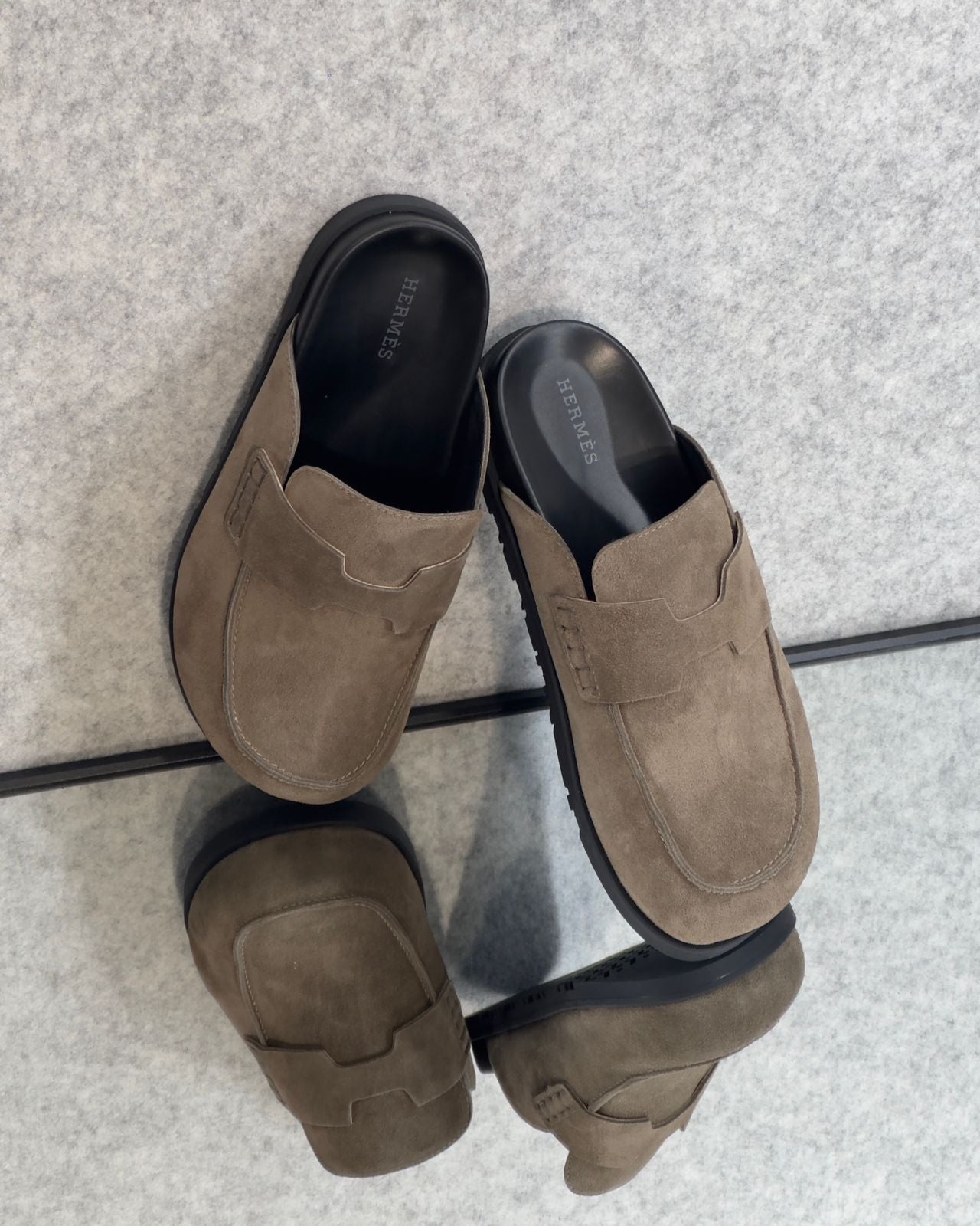 Hermès Go mules in brown suede.
