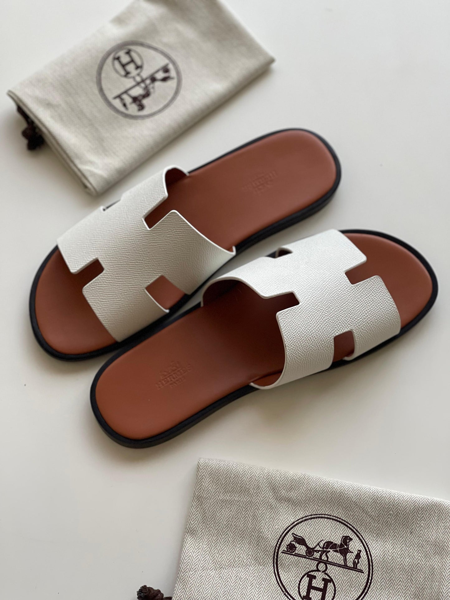 Hermès Izmir Sandal in white calfskin leather iconic "H" cutout.