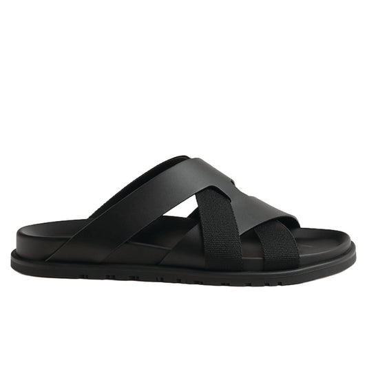 Hermès Kazimir sandal, crafted from black leather and fabric straps featuring an interlaced "H" silhouette.